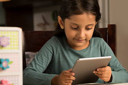 young child using free reading tools for kids on a tablet at home