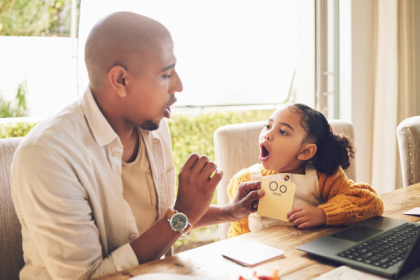 parent and child practicing how to teach sight words at home with flashcards at table