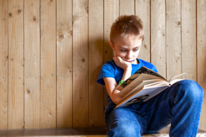 child pushing away book frustrated