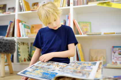 Child reading a graphic novel and children's books