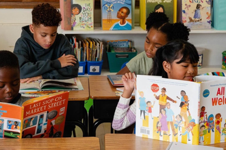Child reading a book in preparation for the new school year