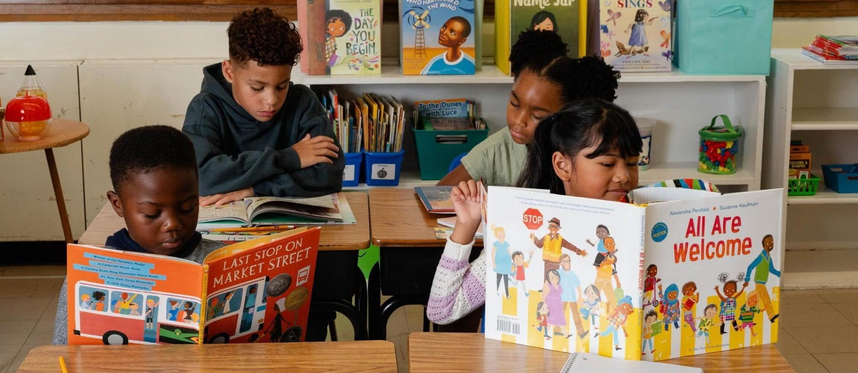 Child reading a book in preparation for the new school year