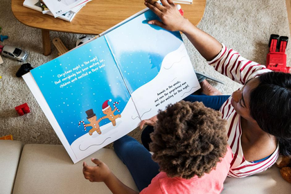 Parent reading aloud to kids at home